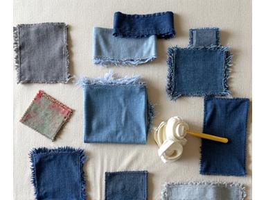 A close-up of textile scraps and recycled fabric swatches being sorted for creative reuse.
