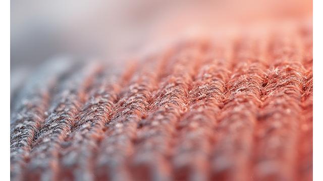 Fabric swatch with faint color bleeding onto a lighter section.