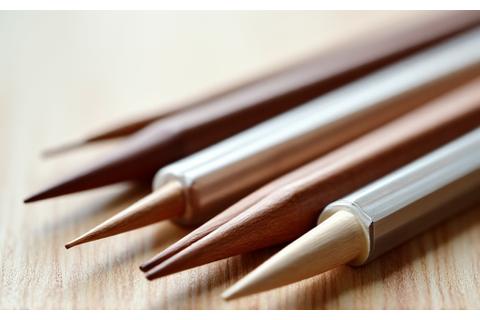Variety of knitting needles: straight, circular, and double-pointed, made from wood, metal, and plastic.